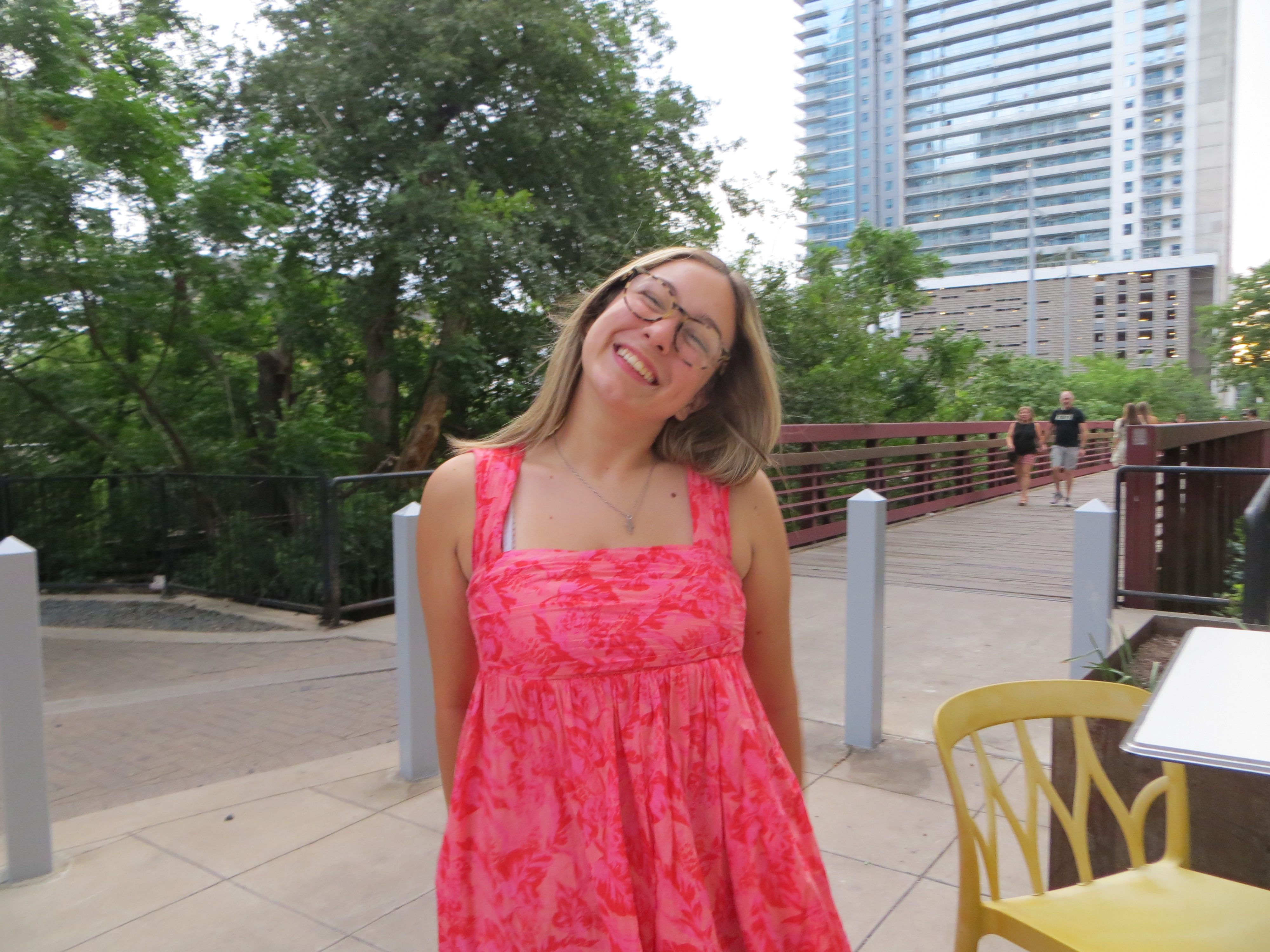 A photo of Alexis smiling outdoors